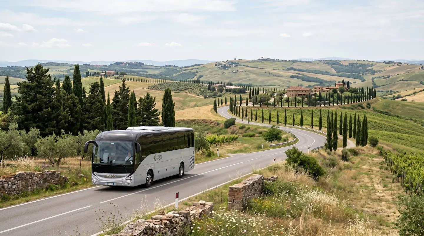 A modern Tootbus vehicle travels along a sunny Tuscan country road lined with cypress trees and rolling hills
